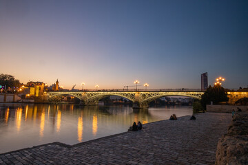 Obraz premium Isabel II Bridge or Triana Bridge in Seville, Spain at sunset