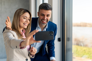 Mid Adult Business Professionals Taking Selfie in Office