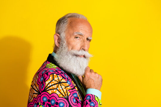 Photo portrait of nice senior male look minded serious camera wear trendy colorful pink fancy outfit isolated on yellow color background