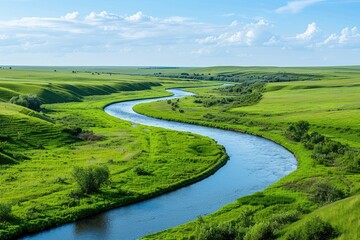 A serene scene of a river flowing peacefully through a lush green field