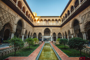 Fototapeta premium Main courtyard of the Alcázar of Seville, with reflecting pond and sunken gardens in Spain