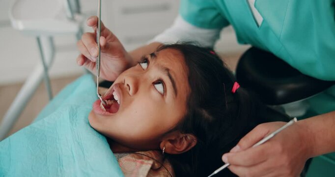 Girl, dentistry and oral surgery with dentures for teeth hygiene, treatment and removal. Doctor, surgeon and scared kid on consultation for extraction at medical clinic on canal procedure or care