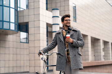 Cheerful Businessman Enjoying Coffee Break with Bicycle