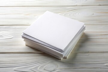 Fototapeta premium Close-up of square paper sheets stack on white wooden table