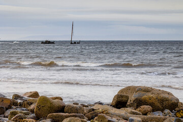 SS or MV Kaffir Clyde puffer wreck rusting abandoned in waves north of Ayr Harbour with Isle of...