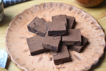 Japanese Nama Chocolate is a type of ganache, which is made from a mix of melted cacao and fresh cream. The block of chocolate cut into pieces and sprinkled with cocoa powder.