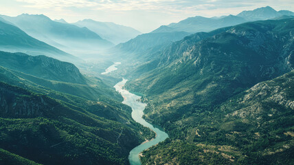Aerial view of mountain range with winding river, showcasing stunning natural beauty