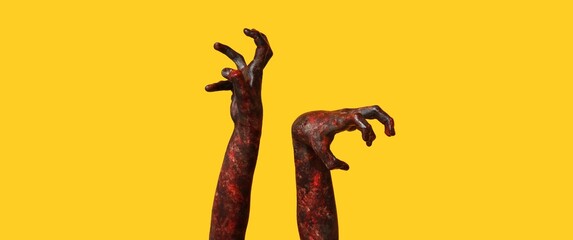 Bloodstained hands of zombie on yellow background. Halloween celebration