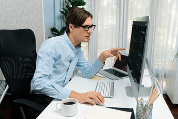 IT developer selecting by point on coding online software development information on pc comparing...