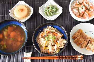 Takikomi Gohan is a Japanese rice dish with short-grain rice with vegetables, mushrooms, seafood, or meat. Often served with pickels and miso soup.