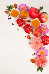 Autumn banner with honey, apples, pomegranates, flowers, dried fruits on light background,...