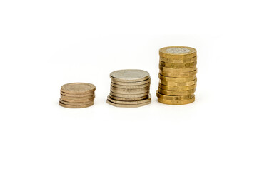 Concept for cost of living, inflation with piles of coins rising in height isolated on white background