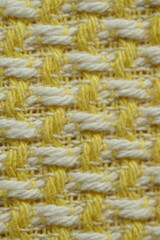 Close-up of the texture of tweed yellow and white fabric, close up of the tweed cotton fabric 