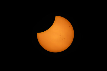 Orange partial solar eclipse 25 Oct 2022 at 10:45:34 from South Ayrshire Scotland with sun spots and limb darkening