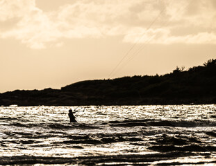 Kite surfing in a windy evening.