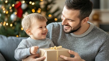 A father and son share a heartwarming moment on the floor, smiling and enjoying a gift together, surrounded by a beautifully decorated Christmas tree