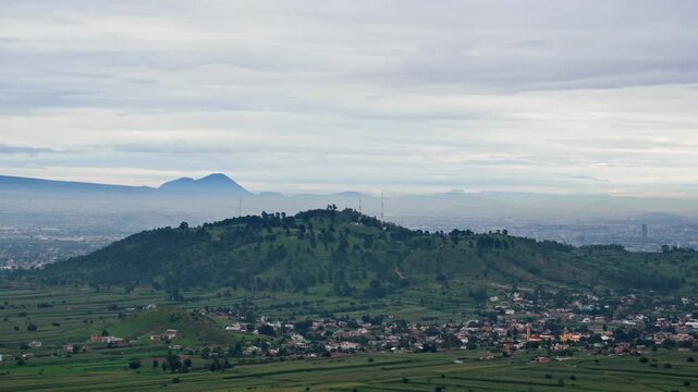 Cerro Zapotecas amidst dense clouds during sunrise in Cholula Puebla