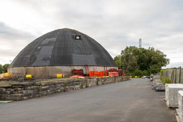 Dry salt store domed building, road barriers, and yard at winter public salt supply depot © Tosh Lubek