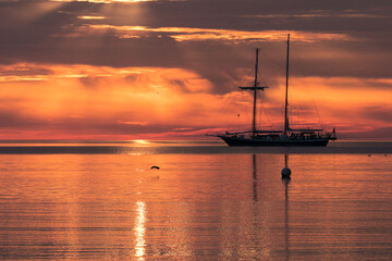 Silhouette of a two mast sailing vessel with dramatic sky, © Lars Gieger