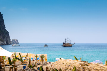 Fototapeta premium Tourist ships at sea on coast of Alanya. Landscape view of Mediterranean coast, Alanya, Turkey