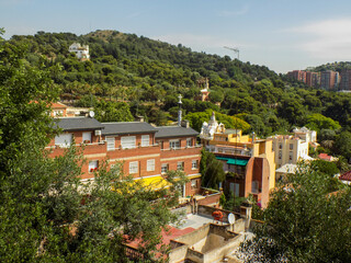 Parque Guell, a monument to Antonio in Barcelona, Spain, , Gaudi looking at the Main Pavilion from the top of the Park