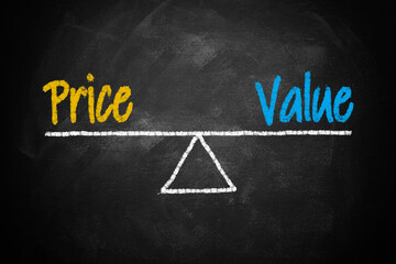 Text word price and value balance on seesaw drawing writing on chalkboard or blackboard background. Concept of price, value analysis in product, business and investment. Real photo, not illustration.