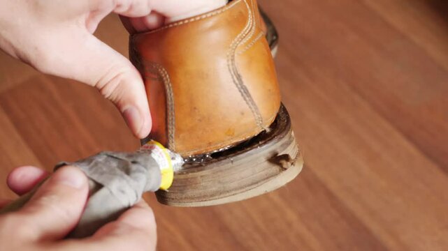 Repairing the soles of old shoes using glue close-up