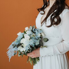 An elegant bride is gracefully holding a stunning floral bouquet, set against a warm and inviting...