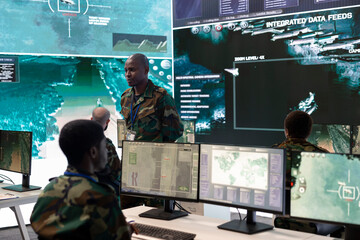 Weapons and targeting systems specialist examining surveillance footage to provide insight for a...