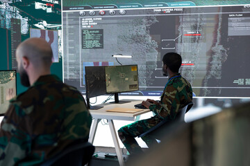 Team of national guard machinists operating on CCTV satellite system, gather intelligence via...
