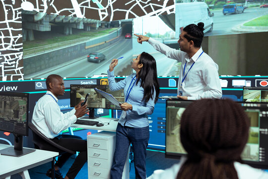 Indian managers instructing their staff how to use CCTV footage and provide gps coordinates to couriers. Monitoring room operators using satellite map for order tracking, cargo surveillance.