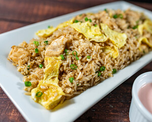 chaufa rice with chicken chunks, accompanied by homemade creams