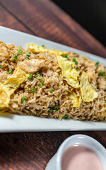 chaufa rice with chicken chunks, accompanied by homemade creams