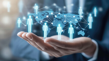 A hand holding a globe with people on it. The globe is blue and the people are in different colors. Concept of a global community and the importance of working together