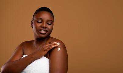 Daily Skincare Routine. Portrait of young nude African American woman wrapped in white towel...