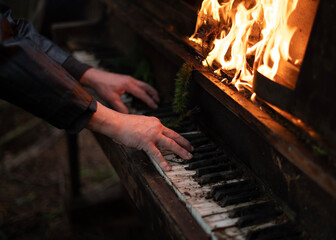 Close-Up of Hands of a Person Playing Piano on Fire