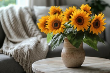 a minimalist living room features a ceramic vase with sunflowers on a wooden coffee table, next to a grey sofa © Aliaksandra