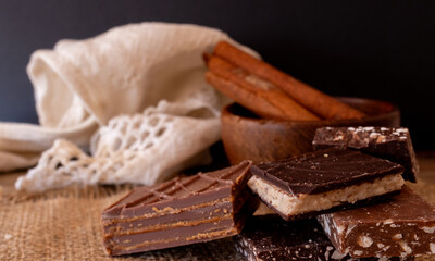 Decorative stack of different flavoured chocolates in a rustic kitchen.