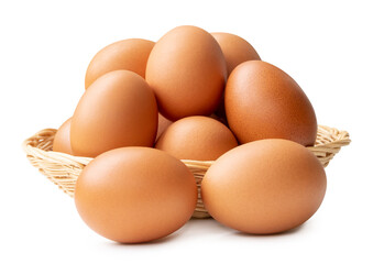 Group of fresh brown chicken eggs in stack in wicker basket isolated on white background with clipping path