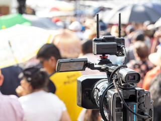 Video camera with background of people with blurred backgrounds