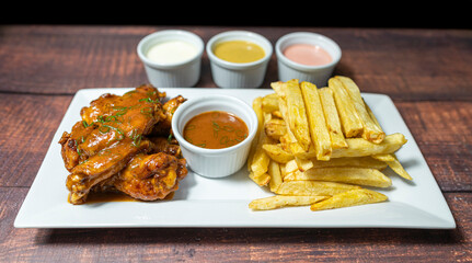 bbq wings with french fries and homemade sauces
