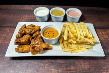 bbq wings with french fries and homemade sauces