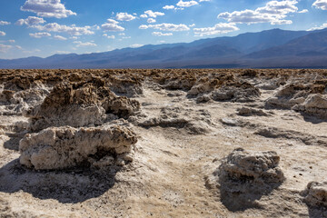 Salt formations and rugged terrain at Devil's Golf Course in Death Valley, California. The desolate landscape is famous for its salt encrustations and harsh, arid conditions.