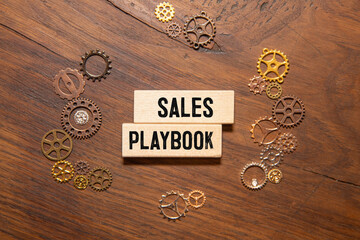 sales playbook text on paper on the chart background with pen