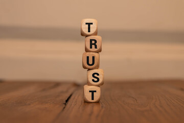 Close up of the word TRUST composed with scrabble letters.