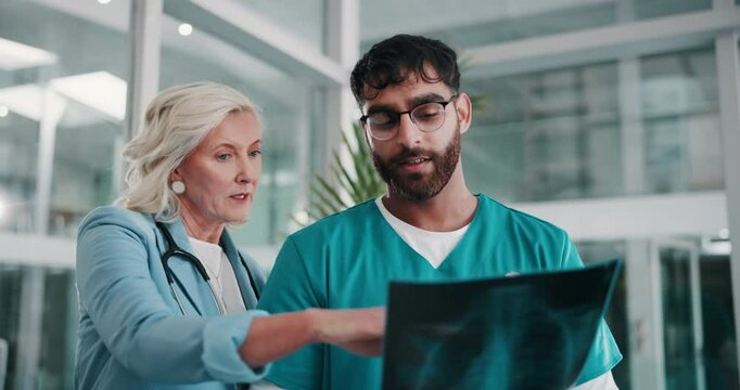 Doctor, medical team and discussion with x ray or CT scan for exam, test or analysis in boardroom at hospital. People, radiologist or healthcare employees with MRI or radiology for anatomy at clinic