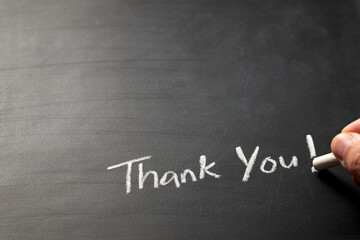 Hand writing Thank You word on blackboard