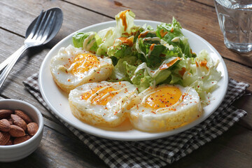 Simple healthy breakfast of fried eggs and salad