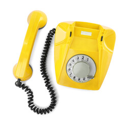 Old yellow telephone with rotary dial isolated on white, top view