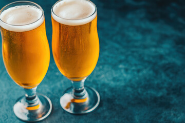 Two frothy pints of beer against a dark textured background, ideal for celebrating moments, beer tasting events, or pub atmosphere imagery.